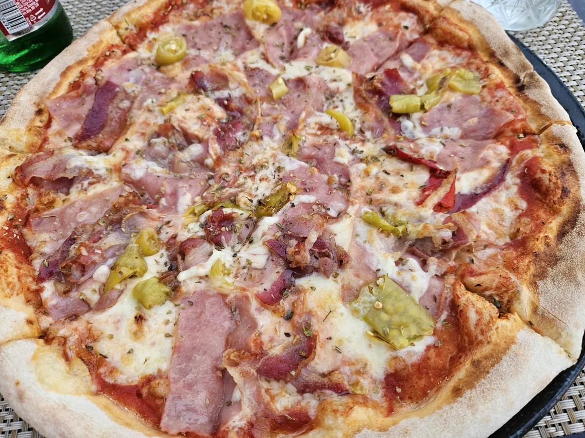 A thin-crust pizza topped with ham and mushrooms at Mirkec, Trogir